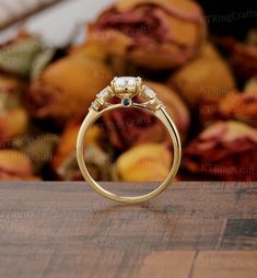 an engagement ring sitting on top of a wooden table