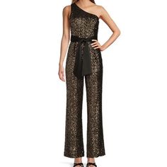 From Antonio Melani, The Skirt Features: Jumpsuit Silhouette One Shoulder Neckline Sleeveless; One Strap Full Length Self-Tie Sash At Waist Straight/Hemmed Approx. 30.75" Inseam Polyester/Rayon Blend Dry Clean Imported. Approx: Pit To Pit 16” Waist 14” Elegant Sequined Cocktail Jumpsuit, Elegant Jumpsuits And Rompers For Gala Party Season, Glamorous Sleeveless Jumpsuits For Holidays, Glamorous Festive Evening Jumpsuits And Rompers, Festive Glamorous Evening Jumpsuits And Rompers, Elegant Holiday Party Jumpsuits And Rompers, Festive Chic Fitted Jumpsuits And Rompers, Elegant Festive Evening Jumpsuits And Rompers, Elegant Jumpsuits And Rompers For Holiday Cocktail