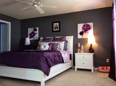 a bed room with a neatly made bed and purple comforter