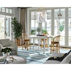 a living room filled with lots of furniture next to a dining room table and chairs