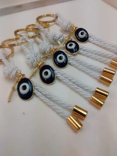 "Evil eye martyrika for the Orthodox baptism day-key ring favor Beautiful martyrika with evil eye and cross in golden shade .They can also be used as favors Key ring's diameter is 0.74\"x0.47\" Evil eye's diameter is 0.6\" Total weight including the key ring, about 4,72\" All your guests will leave with a keepsake from your baptism so as to remember it for long. This listing is for ten(10) pc Thank you for visiting!" Handmade Gold Keychains For Gifts, Baptism Favors, Wedding Item, Key Chains, Key Ring, Key Rings, Christening, Evil Eye, Key Chain