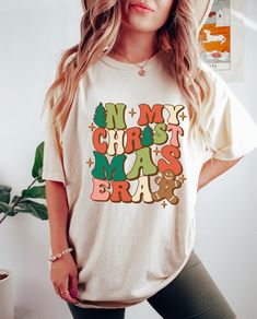 Step into the holiday spirit with our Vintage Christmas Gift T Shirt! Celebrate the Christmas Vibes in this Cute Retro Christmas Party Tee.  In My Christmas Era Shirt, In My Christmas Era, Christmas Era Tee, Christmas Era Tshirt, Christmas Vibes Tee, Womens Christmas Tee, Xmas Holiday Shirt, Vacation Shirt, Christmas Party Tee, My Christmas Era Tee, Era Tshirt, Girl Era Shirt, Christmas Family Tee, Christmas Era Vibes Tee, Vintage Party Shirt, Holiday Season Shirt 👉 Product Details: The T-Shirts, V-Necks, youth and baby suits(onesie) are unisex.👈 👉Please review all the sizing charts that were added in the product pictures. 👚 Women: Shirts will have a looser fit when choosing your regular size. If you would prefer a more fitted look, it is recommended to size down. It is based on your p Retro Christmas Party, Vintage Christmas Gifts, Womens Christmas, Family Tees, Christmas Vibes, Holiday Shirt, Vintage Party, Xmas Holidays, Christmas Family