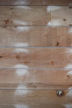 wood planks with white clouds painted on the top and bottom part, in an unfinished room