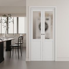 an empty kitchen with two chairs and a table in front of the glass door that leads to another room