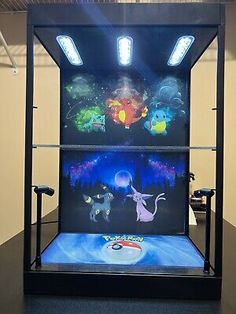 a display case with pokemon pictures on the front and back sides, in an empty room