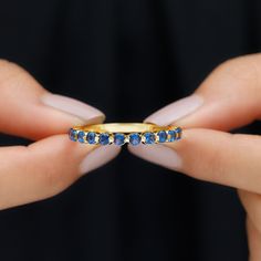 Product Details This stunning Half Eternity Band Ring is graced with the brilliance of Round Shape Created Blue Sapphire Gemstones, delicately placed along the band in a Floating Setting. Each gemstone appears to effortlessly float, creating a mesmerizing and elegant design. Product Information SKU SHP-RINGS052182020 Width 2 mm Height 2.1 mm Weight 2.00 gm (Approximate) LAB CREATED BLUE SAPPHIRE INFORMATION No.of Stones 14 Pieces Total Weight 0.56 Carat (Approximate) Dimension(approx) Round-2X2 Blue Round Eternity Band With Prong Setting, Gold Sapphire Eternity Band With Prong Setting, Gold Sapphire Eternity Band As Gift, Blue Cubic Zirconia Eternity Band With Prong Setting, Blue Prong-set Eternity Band For Anniversary, Blue Eternity Band With Prong Setting For Anniversary, Sapphire Eternity Band Fine Jewelry, Yellow Gold Sapphire Eternity Band For Promise, Blue Cubic Zirconia Round Cut Eternity Band