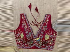 Shop maroon embroidered sleeveless saree blouse online in USA. Elevate your saree style with exquisite readymade saree blouses, embroidered saree blouses, Banarasi sari blouse, designer saree blouse, choli-cut blouses, corset blouses from Pure Elegance Indian fashion store in USA. Embroidered V-neck Saree For Festivals, Sleeveless Embroidered Traditional Wear For Festive Occasions, Festive Sleeveless Embroidered Traditional Wear, Embroidered Saree For Festivals, Traditional Sleeveless Embroidered Fabric For Diwali, Sleeveless Anarkali Choli With Floral Embroidery, Sleeveless Embroidered Fabric For Diwali, Sleeveless Anarkali With Floral Embroidery, Semi-stitched Sleeveless Traditional Wear For Festivals