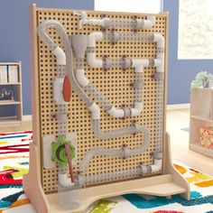 a wooden structure with pipes on it in a child's playroom or bedroom