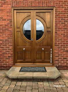 the front door to a brick building with two double doors on each side and an entry step