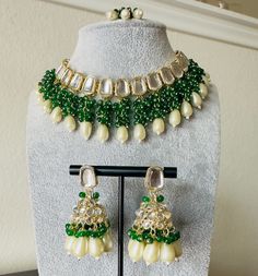 Green Pearl Kundan Choker Necklace Earring and Maang Tikka Set. Earrings dimensions  Length: 2.5 inch Width: 1 inch Ethnic Wear. Can be worn for engagement and wedding parties. Indulge in it or gift it and watch the compliments flow! It is advisable to store jewelry in a zip lock pouch (air tight pouch), keep away from water perfume and other chemicals and clean it with dry and soft cloth. FREE SHIPPING!! Eid Party Jewelry With Cutdana, Bollywood Kundan Necklace With Gota Work For Navratri, Bollywood Style Festive Necklace With Gota Work, Festive Jewelry Sets With Latkans For Eid, Eid Celebration Jewelry Sets With Latkans, Eid Celebration Chandbali Jewelry Sets, Kundan Necklace For Navratri Bollywood Style, Kundan Jewelry Sets With Latkans For Eid, Bollywood Necklace With Latkans For Eid