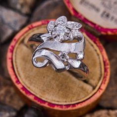 a diamond ring sitting on top of a wooden box