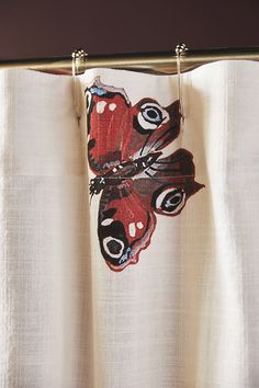 a curtain with a butterfly drawn on it