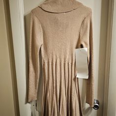 Very Gorgeous Sweater Dress From Calvin Klein. Isize Is L. The Length Is In Pictures. Fron Underarm To Underarm Stretches Comfortably To 19 Inches. I Would Say The Color Is Tan With Some Gold Shine On It. Beige Stretch Mini Dress For Fall, Stretch Beige Mini Dress For Fall, Cream A-line Mini Dress For Fall, Beige Fitted Mini Dress For Fall, Fitted Beige Mini Dress For Fall, Chic Calvin Klein Dresses For Fall, Fitted Beige Fall Dress, Neutral Fitted Long Sleeve Dress, Fitted Beige Midi Dress For Fall