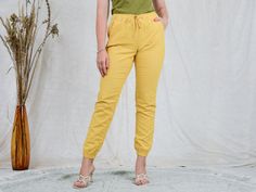 "AUNT GERTRUDE PRESENTS - vintage yellow linen pants - elastic waist - 2 pockets - materials: linen CONDITION (1-10 ❶❷❸❹❺❻❼❽❾ Great condition. SIZE/MEASUREMENTS size from label: EUR 38, FR 40, GB 10 best fits: M/L waist: 31,5-39,5 inches (80-100 cm) hips: 39,5 inches (100 cm) rise: 10 inches (25 cm) length: 39,5 inches (100 cm) inseam: 31 inches (78 cm) The model is 5'9\" (174 cm), measures 35-27-38 (90-69-96 cm) and wears size M" Yellow Summer Cargo Pants, Yellow Ankle-length Pants With Elastic Waistband, Yellow Straight Leg Bottoms With Elastic Waistband, Yellow Cotton Cargo Pants For Summer, Yellow Straight Pants With Elastic Waistband, Yellow Pants With Elastic Waistband, Yellow Relaxed Fit Ankle-length Pants, Yellow Linen Bottoms For Spring, Casual Yellow Ankle-length Bottoms