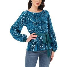 Step into the holiday season with style in the Anna-Kaci Women's Sequin Party Tie Waist Sweatshirt Pullover Top. This bedazzled pullover sweater features glittery sequins from top to bottom, combining festive sparkle with cozy comfort. With its round neckline, cuffed long sleeves, and relaxed fit, it's perfect for adding a touch of glamour to your winter wardrobe. Blue Long Sleeve Winter Blouse, Winter Party Sweater With Long Sleeves, Fall Party Blouse With Crew Neck, Glamorous Long Sleeve Winter Top, Winter Long Sleeve Sequin Top, Winter Party Long Sleeve Tops, Long Sleeve Winter Party Tops, Long Sleeve Party Top For Winter, Long Sleeve Tops For Winter Party