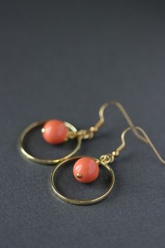 This lovely earrings was made of peach coral color glass 10 mm beads, gold plated brass bead caps, gold tone open circle charms and gold plated brass base earrings hooks. Earring hooks are from nickel free and lead free metal. *The total lenght of earrings is about 45 mm including earring hooks. Other earrings of my shop you can see here: https://www.etsy.com/shop/NaTavelli?section_id=13757927 Thanks for visit. Nickel Free Orange Hoop Earrings, Handmade Orange Brass Earrings, Orange Metal Jewelry With Matching Earrings, Orange Circular Jewelry As A Gift, Orange Circular Jewelry Gift, Minimalist Orange Drop Earrings, Orange Dangle Earrings Minimalist Style, Orange Minimalist Dangle Jewelry, Minimalist Orange Dangle Jewelry