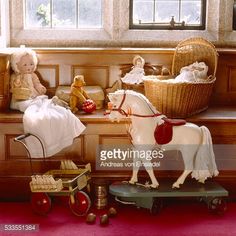 there is a toy horse and other toys on the floor in front of a window