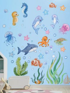 an ocean scene with various sea animals and marine life on it's blue wall