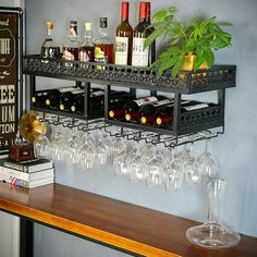 a shelf with wine glasses and bottles on it