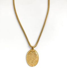 "This lovely antique-style pendant dates to around the 1980s and is engraved on both sides in the style of a monogram. The last photo shows the pendant on a size 12 mannequin. The lightweight snake chain is 19\" long = 48cm.  Including the top loop the pendant hangs down 3.5cm. The dimensions of the oval pendant are 3.2cm x 2.5cm = 1.1 x 1 inch.    It is in excellent condition with no visible signs of wear. PLEASE READ: Vintage jewellery is anything dating from 1980s and up to 100 years old; any Monogram Pendant, Engraved Pendant, Necklace Antique, Gold Monogram, Pendant Gold, Oval Pendant, Gold Plated Necklace, Victorian Style, Vintage Jewellery