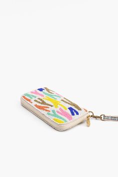 Our Rainbow Sprinkles Wallet is an elegant and versatile accessory designed to seamlessly blend style and functionality. This sophisticated Wallet is not just a fashion statement; it's a practical solution that combines a top zip compartment with an integrated wallet for all your essentials.The top zip closure provides a secure and convenient way to access your belongings. Keep your essentials safe and organized with easy access to the main compartment Hand Embellished with Top Zip Clutch Made i Trendy Travel Wallets With Zipper Closure, Trendy Travel Wallet With Zipper Closure, Trendy Everyday Wallets With Zipper Closure, Trendy Wallet With Zipper Closure For Everyday Use, Modern Rectangular Wallets With Zipper Closure, Multicolor Coin Purse With Zipper For Daily Use, Trendy Multicolor Wallets With Removable Pouch, Multicolor Clutch With Zipper Closure For Daily Use, Modern Clutch Wallet With Zipper Closure