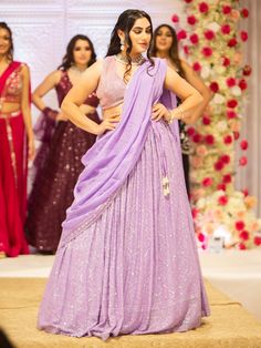 Embrace elegance and grace with the Samantha Lehenga. Crafted with intricate mirror, pearl, and stone embroidery work, this whimsical lehenga exudes a sense of grandeur, making it perfect for special events and occasions. Key Features: Precious mirror, pearl, and stone embroidery work Lavender color exuding beauty and grace Soft net fabric for a gorgeous and elegant look Elevate your style with the Samantha Lehenga, designed to bring out your innate grace and elegance. The silk blouse adorned wi Samantha Lehenga, Elegant Party Lehenga With Gota Work, Elegant Designer Choli With Gota Work, Elegant Pre-draped Kundan Saree For Party, Georgette Anarkali Set With Sequins For Receptions, Sequin Georgette Anarkali Set For Reception, Elegant Pre-draped Saree With Kundan For Party, Elegant Kundan Pre-draped Saree For Party, Elegant Designer Lehenga With Sequins