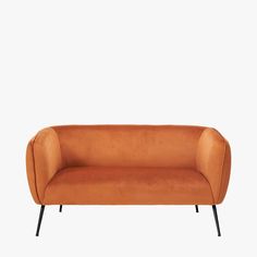 an orange couch with black legs on a white background