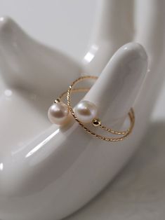 Experience the timeless charm of our 14K Gold-Filled Freshwater Double Pearl Wrapped Wire Ring Elevate any ensemble with its luxurious touch, modern design, adjustable fit, and versatile styling. Make a statement of elegance and sophistication wherever you go. Metal: 14K Gold Filled Gemstone: Freshwater Pearls Pearl Diameter: 5.5-6mm Size: Adjustable 6-8 Weight: 1g Luxury Gold Pearl Open Ring, Luxury Open Pearl Ring, Luxury Pearl Ring With Pearl Charm, Elegant Adjustable 14k Gold Filled Rings, Elegant 14k Gold Filled Promise Ring, Elegant 14k Gold-filled Promise Ring, Elegant Adjustable Rose Gold Rings, Adjustable 14k Gold Pearl Ring, Elegant Pearl Toe Ring For Anniversary