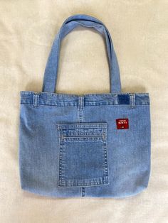 a denim bag with a red tag on it