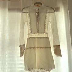 a white dress hanging on a window sill