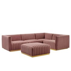 a pink couch and ottoman with gold legs