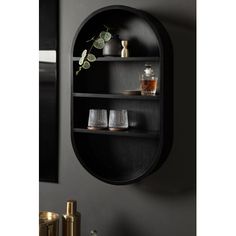 a black shelf with some glasses on it