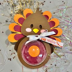 a turkey ornament with an orange ball in it