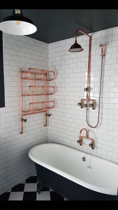 an old fashioned bathtub in a bathroom with black and white checkered flooring