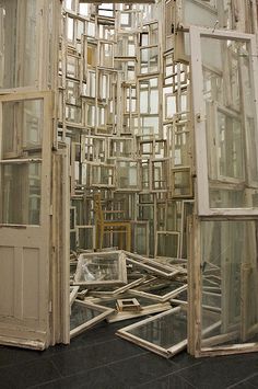 there are many windows that have been made out of old doors and frames on the floor