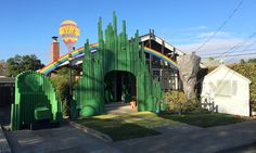 a large green building with a rainbow painted on it