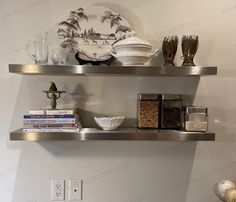 two metal shelves with plates and bowls on them