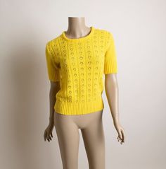 "FREE DOMESTIC SHIPPING! ♥ Cute vintage 1970s bright yellow knit sweater top!  ♥ Pullover style, short sleeves, nice flattering fit! ♥ Peek-a-boo flower & striped designs on the front! Solid back. ♥ In great condition! No label tag, washable.  * measurements * Bust - 36\" Waist - 30-32\" Length - 21\" Very comfy & stretchy!  ** I do ship worldwide! For more vintage cuteness, check out my store: → http://zwzzy.etsy.com ← ❀ Instagram - Zwzzy ❀ Twitter - http://www.twitter.com/zwzzy ❀ Facebook - ht Retro Textured Knit Sweater For Spring, Retro Textured Knit Spring Sweater, Retro Textured Knit Crew Neck Top, Retro Knit Stretch Sweater, Retro Stretch Knit Sweater, Yellow Knitted Crew Neck Top, Fitted Yellow Crew Neck Sweater, Retro Knit Tops For Spring, Retro Mustard Tops For Fall