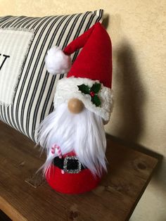 a santa clause pillow sitting on top of a wooden table