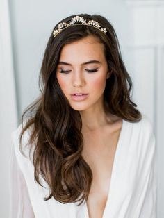 a woman with long hair wearing a tiara