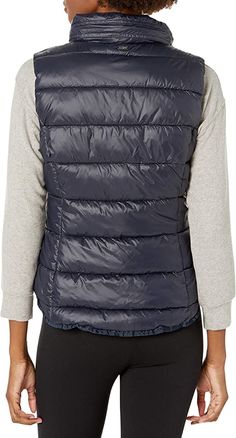 Women's Puffer Vest In Blue With Removable Hood Stay cozy and chic with this women’s puffer vest in blue, featuring a versatile removable hood. Made from 100% nylon, it offers lightweight warmth with a sleek finish. The zippered closure and turtle neck collar provide added protection against the cold, while two side zip pockets and an inner pocket offer convenient storage. Perfect for layering, this blue puffer vest combines practicality and style, making it an ideal choice for cool-weather adve Navy Nylon Outerwear For Outdoor, Navy Nylon Functional Outerwear, Navy Windproof Nylon Outerwear, Navy Nylon Windproof Outerwear, Casual Polyamide Outerwear For Outdoor, Casual Polyamide Outerwear For Winter, Blue Windproof Nylon Outerwear, Versatile Stretch Blue Outerwear, Functional Blue Down Outerwear