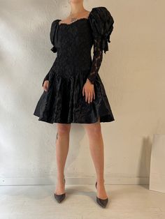 - Vintage black lace puff sleeve party dress - Lace sleeves and bodice - Zipper up the back - Sequins lining the bust  - Nylon acetate polyester - Made in USA - Tagged 9 Bust: 16.5" Waist: 14" Length: 35.5" We are not responsible for lost, stolen, or damaged packages once they have been shipped. Any additional customs duties or taxes incurred on international orders are the responsibility of the buyer. Please note that our items are vintage and may have minor flaws or imperfections due to their Party Dress With Puff And Balloon Sleeves, Party Dress With Puff Balloon Sleeves And Fitted Bodice, Fitted Puffy Evening Dresses, Black Puff Sleeve Mini Dress For Evening, Evening Dress With Puffy Sleeves, Evening Dresses With Puff Sleeves, Evening Puff Sleeve Puffy Dress, Party Puff Sleeve Dress With Ruffles And Balloon Sleeve, Black Puff Sleeve Dress For Cocktail