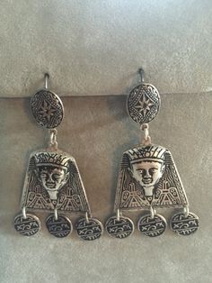 Stunning, statement earrings from 1970s Spain. Pharaoh heads dominate the design with flanking birds. Silver disks with 'hieroglyphics' dangle from the heads.  These are textured silver (color), lever back, earrings. The style is called Damascene. Because they are Good, Vintage costume jewelry they do have sterling silver content - but not rated at 925. The earrings measure just over 2 1/8" (5.4cm) long from top to bottom. These earrings are from the inventory of 2 fantastic gift shops that were Gift Shops, Bohemian Hippie, Hippie Bohemian, Pierced Earrings, Pretty Jewellery, Vintage Costume Jewelry, Star Earrings, Fantastic Gifts, Vintage Costumes