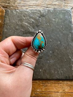 Handmade Sierra Bella Turquoise and sterling silver ring.  Will fit Size 7.5 US. American Southwest vintage style design. Beautiful striking teal green-blue colored turquoise with unique sandy brown colored matrix.  Simple design and petite sized, and twisty rope trim. Hand polished Rustic looking patina.  Chunky split style shank/band. Hand stamped Indian style arrow and rising sun hallmark on backside.  100% Sterling silver. --------------------- Every piece will come packaged in a recycled kr Blue Teardrop Western Style Jewelry, Western Teardrop Jewelry Gift, Southwestern Blue Teardrop Ring, Southwestern Teardrop Blue Rings, Handmade Southwestern Teardrop Rings, Southwestern Turquoise Teardrop Ring, Southwestern Style Teardrop Turquoise Ring, Southwestern Teardrop Turquoise Ring, Southwestern Teardrop Turquoise Gemstone Ring