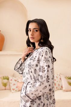 Batik Omari 2Pc - Printed Lawn Dress Embrace summer with this ready-to-wear 2pc dress. Crafted from premium quality Pima lawn in elegant white tones, the short-length shirt features a v-cut neckline enhanced with lace and collage. The loose-fit sleeves are adorned with lace and pleats at the hem, adding a touch of sophistication. It is paired with printed cambric culottes in contrasting colors, making it a chic ensemble for any occasion. Disclaimer: Colors may slightly vary due to lighting. Elegant Summer Sets With Printed Motifs, Printed Tunic Sets For Summer, Summer Printed Tunic Sets, Elegant Printed Straight Kurta Set, White Tunic Dress For Eid, White Long-sleeved Summer Sets, Elegant White Summer Sets, White Printed Motif Fabric Sets, Unstitched White Sets With Printed Motifs