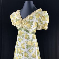 "Maxi dress from about 1968 with empire waistline marked with green ribbon that rises to a point in front w/ 3 satin covered front buttons. Yellow cabbage roses on sheer fabric with green leaves over a fully lined dress. Wide V neckline front and back, trimmed with 1.5\" wide lace even down the back & around a wide hem ruffle. Size Small Bust: 34\" Waist: 25\" Hips: 34\" Sleeves: 13.5\" Length: 62\" A lovely bridesmaid dress or add a wide brim hat for a garden party. Dress is in excellent co Vintage Green Dress For Garden Party, Regency Style Fitted Vintage Dress For Garden Party, Fitted Regency Style Vintage Dress For Garden Party, Fitted Cottagecore Vintage Dress With Empire Waist, Cottagecore Fitted Vintage Dress With Empire Waist, Vintage Empire Waist Dresses For Garden Party, Green Fitted Cottagecore Vintage Dress, Empire Waistline, Cabbage Roses