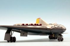 a model jet plane with wheels on the front and side, against a white background