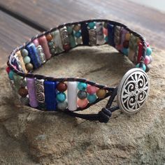 This multi color beaded bracelet for women is stunning and unique. This single wrap bracelet would compliment and outfit you want to wear it with. This bracelet would be a beautiful meaningful gift for your mother on Mother's Day. It will be a gift she can enjoy every day. This leather beaded bracelet is made with a variety of gemstone beads in various sizes and colors. Please choose the size you would like at check out. Spiritual Multicolor Adjustable Wrap Bracelet, Beaded Wrap Bracelet For Gift, Adjustable Colorful Beads Wrap Bracelet, Adjustable Multicolor Beaded Crystal Bracelet, Adjustable Multicolor Spiritual Cuff Bracelet, Colorful Bead Wrap Bracelet Gift, Festival Wrap Bracelet With Round Gemstone Beads, Festival Gemstone Beads Wrap Bracelet, Hand Wrapped Friendship Bracelet With Round Beads