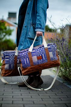 Whether you're planning a little overnight getaway, a day trip, or just like to carry around everything but the kitchen sink, this bag is for you. Made from sustainable and vintage materials and designed to last, it will be your go-to for many years to come. Overnight Duffel Dimensions: Body: 19" Long x 12" Tall x 6" Wide. Straps: 20" Handles, 65" Shoulder Strap (at longest setting). Features: 12 oz. Waxed Canvas Reinforced Canvas & 100% Cotton Webbed Handles Removable & Adjustable 100% Cotton Webbed Shoulder Strap. Antique Brass Hardware & Zippers Vintage Antique Overshot Coverlet Body 10 oz. Olive Ripstop Lining Zippered Interior Pocket Note: Each Purple Coverlet Duffle is made from the same overshot coverlet textile, pattern placement will vary, making each bag just the right amount of Rectangular Canvas Weekender Bag For Overnight Trips, Rectangular Weekender Bag With Leather Handles For Weekend Trips, Weekender Shoulder Bag With Adjustable Strap For Overnight Trips, Vintage Duffle Bag With Adjustable Strap For Travel, Weekender Tote Bag With Adjustable Strap For Overnight Trips, Tote Weekender Bag With Adjustable Strap For Overnight Trips, Weekender Tote Bag For Overnight Trips, Overnight Duffle Bag With Adjustable Strap, Duffle Bag With Luggage Sleeve For Overnight Trips