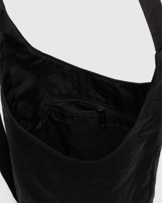 A slouchy, softly structured nylon bag with an adjustable strap. Interior zip pocket with a magnetic closure. The details- Heavyweight nylon (59% recycled) 9.5 in. H × 7 in. W × 4.25 in. D 39 in. adjustable strap Machine washable Black Nylon Hobo Bag With Adjustable Strap, Nylon Hobo Shoulder Bag With Zipper Pocket, Functional Nylon Hobo Bag, Functional Nylon Hobo Bag With Adjustable Strap, Functional Nylon Hobo Shoulder Bag, Functional Nylon Hobo Bag For On-the-go, Nylon Crossbody Bag With Water Bottle Pocket, On-the-go Nylon Shoulder Bag With Water Bottle Pocket, Functional Nylon Hobo Bag With Removable Pouch